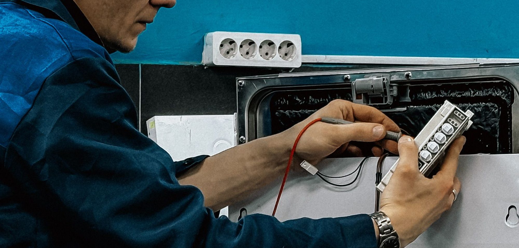 Proven Masters Major Appliance Repairs technician repairing a refrigerator in New York City